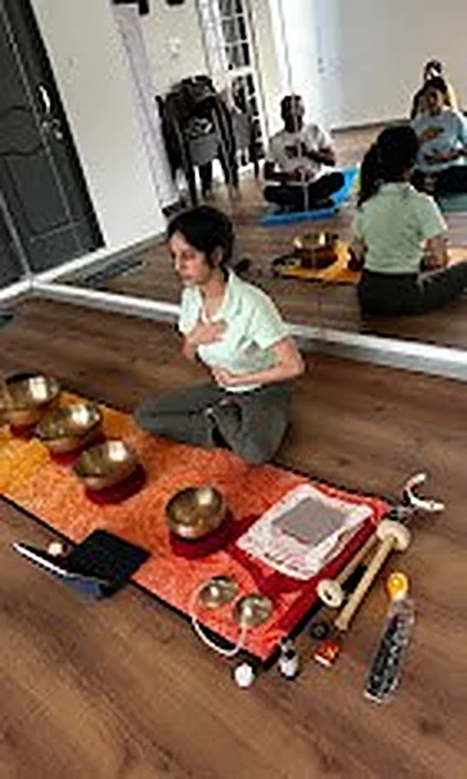 Singing bowls laid out in front of the studio mirror